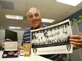 John D'Agostino shows a team picture of the 1964  Sudbury Italia Flyers men's soccer team and some of the hardware the team won that season. The Flyers are gathering to celebrate the 50th anniversary of the team's run to the national championship at the Caruso Club on Wednesday.