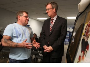Pat Leighton and Mayor Jim Watson discuss the memorial wall at Barrhaven's Walter Baker centre, which was officially opened Monday morning with the unveiling of a plaque and photo of Eric Leighton, who was killed in a high school explosion exactly three years ago. (DOUG HEMPSTEAD/Ottawa Sun)