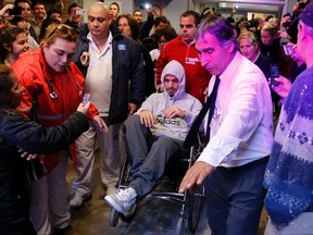 Uruguayan striker Luis Suarez leaves the hospital in a wheel chair after surgery due to a knee injury in Montevideo May 22, 2014. (REUTERS)