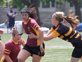 Regiopolis-Notre Dame Panthers’ Hannah Greenwood tries to elude a La Salle Black Knights tackler during the Kingston Area girls rugby championship game at Nixon Field on May 22. La Salle and Regi are both head to Ontario championships. (IAN MACALPINE/THE WHIG-STANDARD)