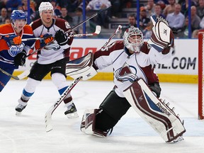 Colorado Avalanche goaltender Jean-Sebastien Giguere (35) makes a glove save against the Edmonton Oilers at Rexall Place earlier this season. (Perry Nelson-USA TODAY Sports)