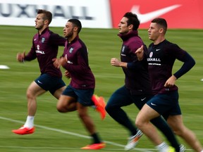 England's national soccer team players run during a training session in Almancil, near Faro, Portugal on May 21, 2014. (REUTERS)