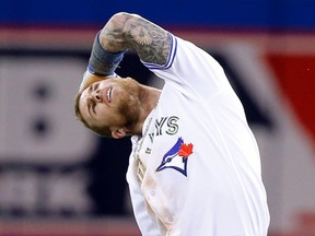 Blue Jays’ Brett Lawrie stretches his neck after jamming it sliding into second safe on a double. Lawrie had another hit and an RBI in the Blue Jays’ 10-5 win over the Rays. (Craig Robertson/Toronto Sun)