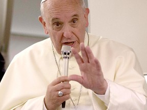 Pope Francis talks to reporters aboard the papal flight on his way back to the Vatican from Jerusalem May 26, 2014.  Pope Francis navigated the minefield of the Israeli-Palestinian conflict and humbly bowed to kiss the hands of Holocaust survivors on Monday, the last day of a Mideast trip laden with bold personal gestures.  REUTERS/Andrew Medichini/Pool