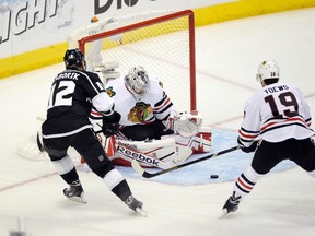 Chicago Blackhawks goalie Corey Crawford (50) makes a save as center Jonathan Toews (19) tries to clear the puck away from Los Angeles Kings right wing Marian Gaborik (12) during the first period Monday at the Staples Center in L.A. (USA TODAY)