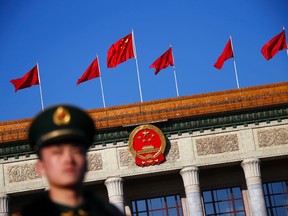 A paramilitary policeman stands outside the Great Hall of the People, the venue holding the closing ceremony of the Chinese National People's Congress (NPC), in Beijing, March 13, 2014. REUTERS/Petar Kujundzic