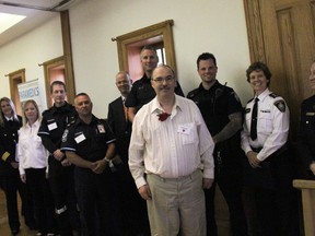 Robert Knight of Strathroy with emergency crews that saved his life, at the Survivor's Day luncheon in London on May 22. ELENA MAYSTRUK/AGE DISPATCH/QMI AGENCY