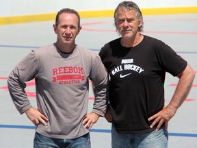 Vytas Darasaka (right) and Paul Barbas stand at the outdoor ball hockey rink they have built in the parking lot at Hiawatha. The pair are bringing the first outdoor ball hockey league to Sarnia, with action set to begin Sunday, June 8. (SHAUN BISSON, The Observer)