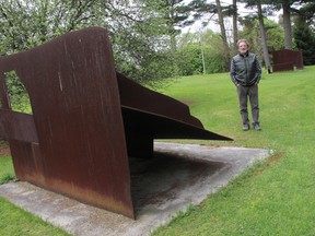 Patrick Thibert next to Axis (1978) one of his earlier outdoor sculptures at the artist's Mount Brydges home. Thibert's abstract art old and new is on exhibit at Museum London until August 24. ELENA MAYSTRUK/AGE DISPATCH/ QMI AGENCY