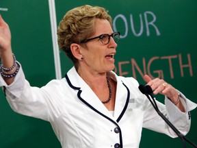 Ontario premier Kathleen Wynne along with her partner Jane, stop off at the Costi Immigrant Services on College St. in Toronto, Ont. to speak with students on Friday May 23, 2014. (Dave Thomas/QMI Agency)