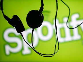 Headsets hang in front of a screen displaying a Spotify logo on it, in Zenica Feb. 20, 2014. REUTERS/Dado Ruvic