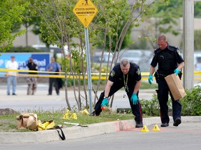 Peel Regional Police forensic officers collect evidence out in front of a grocery store at the Bramalea City Centre after a woman was stabbed repeatedly. (DAVE THOMAS/Toronto Sun)