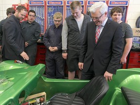Manitoba Premier Greg Selinger examines a dune buggy with auto students at Kildonan East Collegiate in Winnipeg, Man. Tuesday May 27, 2014 after announcing $30 million in funding for trades courses.
Brian Donogh/Winnipeg Sun/QMI Agency