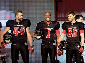 (L-R) Ottawa Redblacks #44 Justin Phillips, #1 Henry Burris and #86 Simon Le Marquand helped unveil their home uniforms in Ottawa on Tuesday, May 6, 2014. (Matthew Usherwood/ Ottawa Sun)