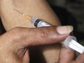 File shot of a man injecting a syringe filled with heroin in his arm.
REUTERS/Kham