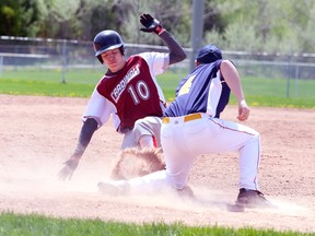 St. Charles Cardinals Todd Timony slides safely into third base as Dillon Reyner of Bishop Carter misses the catch during high school championship baseball action against Bishop Carter from Terry Fox Sports Complex on Tuesday afternoon.