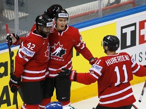 Canada's Joel Ward (L) celebrates his goal against Italy with team mates Mark Scheifele (C) and Jonathan Huberdeau (R) during the first period of their men's ice hockey World Championship Group A game against Italy at Chizhovka Arena in Minsk May 16, 2014.  REUTERS/Vasily Fedosenko (BELARUS  - Tags: SPORT ICE HOCKEY)