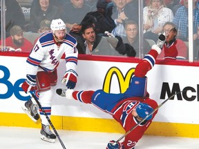 The Rangers' John Moore delivers a late hit to Montreal's Dale Weise in Game 5 of the Eastern Conference final on Tuesday. (Pierre-Paul Poulin/QMI Agency)