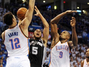 San Antonio Spurs guard Cory Joseph (5) attempts to shoot between Oklahoma City Thunder forward Serge Ibaka (9) and centre Steven Adams during NBA playoff action at Chesapeake Energy Arena Tuesday. (Mark D. Smith/USA TODAY Sports)
