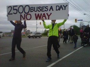 Protesters -- some wearing dust masks -- parade across Albert St. at Preston St. during the morning rush hour on Wednesday, May 28, 2014 to oppose the city's plan to use Albert St. as a bus detour when the Transitway is converted to LRT. JON WILLING/OTTAWA SUN