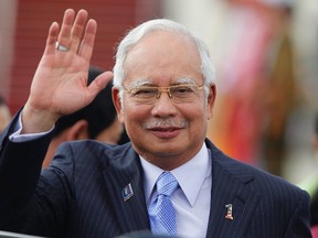 Malaysia's Prime Minister Najib Razak waves as he arrives at Naypyitaw international airport to attend 24th ASEAN Summit May 10, 2014. (REUTERS/Soe Zeya Tun)