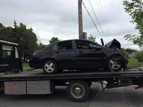 The car that crashed into Eastdale Collegiate and Vocational Institute in Oshawa is towed from the scene. (MARYAM SHAH/Toronto Sun)