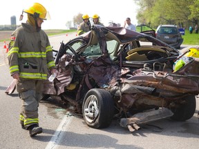 Emergency workers extricate a man from his car after a multi-vehicle collision May 21 on Elgin Rd. An Aylmer man has been identified as the driver. (MIKE HENSEN, QMI Agency)