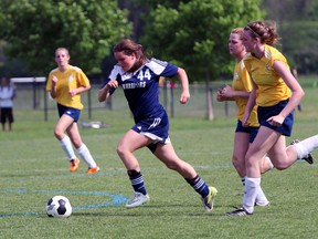 St. Mary's Warriors Katie Ziraldo slips between two Montcalm defenders in the second half of the TVRA Central Division 'AA' finals Tuesday May 27, 2014 in London. The Warriors won 3-0 to advance to WOSSAA Thursday in St. Thomas. (GREG COLGAN, Sentinel-Review)
