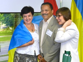 Alisa Riabova, deputy mayor of the Ukrainian city of Pavlograd, London city councillor Harold Usher and tour organizer Kadie Ward wrap themselves in the Ukrainian flag. A delegation of Ukrainian municipal officials were in London Wednesday as part of a tour to learn about Canadian municipal governance. (HANK DANISZEWSKI, The London Free Press)