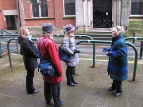Guide Jean Bailo, far right, provides lively commentary to visitors during an outing with Manchester Guided Tours. PATRICIA JOB/QMI Agency