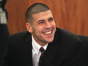 Former New England Patriots player Aaron Hernandez smiles as he appears in court at the Fall River Justice Center in Fall River, Massachusetts December 23,  2013. (REUTERS)