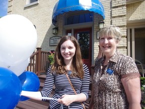 Summer student Katie Holmes and community development co-ordinator Jan Vicars stand  in front of the newly renovated Alzheimer Society of Oxford building during their open house Wednesday. HEATHER RIVERS/WOODSTOCK SENTINEL-REVIEW