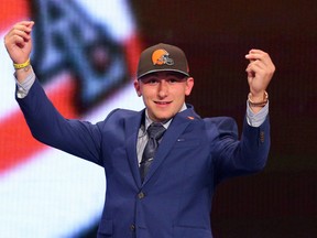 Quarterback Johnny Manziel gestures on stage after being selected by the Cleveland Browns in the first round of the NFL draft at Radio City Music Hall. (Brad Penner/USA TODAY Sports)