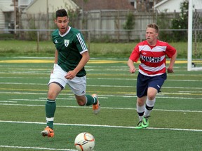 Danielo Bucci (in green) of St. Patrick's runs down a ball while being marked by Matthew Montaleone of Holy Names during their SWOSSAA 'AAAA' senior boys soccer final on Wednesday, May 28 at Norm Perry Park. Holy Names won the game 1-0 on a goal in the 3rd minute and earned a berth into the OFSAA championships. SHAUN BISSON /THE OBSERVER/QMI AGENCY
