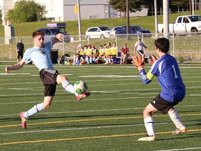 Shawn Wilcox, left, of St. Benedict Bears, attempts to fire a shot past goalie Roberto Bagnato, of Lockerby Vikings, during the high school boys premier division soccer finals at James Jerome Sports Complex in Sudbury on Wednesday evening.