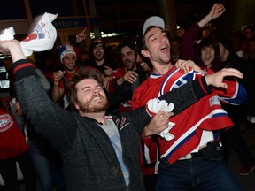 Fans of the Montreal Canadiens celebrate their team's 7-4 win over the New York Rangers on May 27, 2014 outside the Bell Centre. (MAXIME DELAND/QMI Agency)