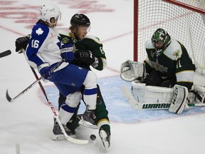 Stars’ Jamie Oleksiak blocks a shot with his foot defending against the Marlies’ Sam Carrick in front of goalie Cristopher Nilstorp at the Ricoh Centre last night. (Jack Boland/Toronto Sun)