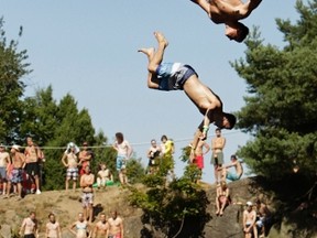 Competitors jump into the water during a cliff diving competition near the central Bohemian village of Hrimezdice August 2, 2013.  REUTERS/David W Cerny