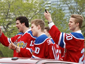Edmonton Oil Kings Brandon Baddock (13), Henrik Samuelsson (10)and Mads Eller (20) cheer as the Memorial Cup-winners were escorted in the back of pickups in a mini-procession down 99th St. to the southern end of Churchill Square downtown Edmonton on Wednesday, May 28, 2014. IAN KUCERAK/Edmonton Sun/QMI