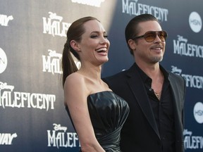 Cast member Angelina Jolie and actor Brad Pitt pose at the premiere of "Maleficent" at El Capitan theatre in Hollywood, California May 28, 2014. REUTERS/Mario Anzuoni