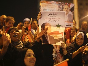 Supporters of Abdel Fattah al-Sisi hold a poster of him as they celebrate at Tahrir Square in Cairo on May 28, 2014. (REUTERS/Mohamed Abd El Ghany)