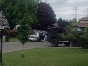 Ottawa police at the Downsview Cres. home of Caroline Budd, 20, on Wednesday. She is charged in two sex assaults on 16-year-old girls at a west Ottawa home during the May 17 long weekend. Also charged is Antonio Comunale, 31. (John Jackson Submitted image)