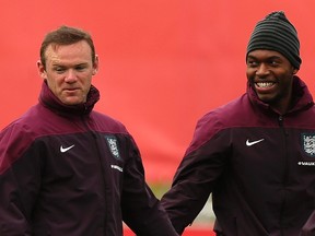 England's Daniel Sturridge (R) laughs with teammate Wayne Rooney during a training session at the St George's Park training complex near Burton-upon-Trent, central England, May 27, 2014. (REUTERS)