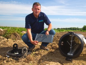 Brad Glasman of the Upper Thames River Conservation Authority shows off a controlled drain system on an Elginfield farm. (MIKE HENSEN, The London Free Press)