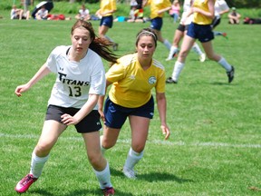 Central Elgin Collegiate Institute player Amanda Legg, left, fends off a Montcalm defender Thursday in their WOSSAA 'AA' soccer bronze medal game. CECI won 6-0. Ben Forrest/Times-Journal