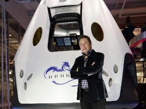 SpaceX CEO Elon Musk introduces SpaceX's Dragon V2 spacecraft, the company’s next generation version of the Dragon ship designed  to carry astronauts into space, at a press conference in Hawthorne, California, May 29, 2014.  The private spaceflight company’s unmanned Dragon spacecraft has been delivering cargo to the International Space Station three times since 2012. The new Dragon V2 will ferry NASA astronauts to and from the space station. 
AFP PHOTO / Robyn Beck