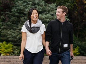 Facebook CEO Mark Zuckerberg walks with his wife Priscilla Chan at the annual Allen and Co. conference at the Sun Valley, Idaho Resort in this July 11, 2013 file photo. REUTERS/Rick Wilking/Files