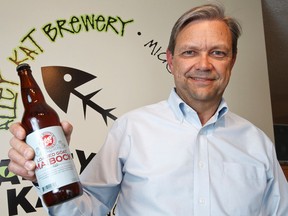 Owner Neil Herbst poses for a photo with a bottle of Loaded Goat Maibock, a seasonal beer, at Alley Kat Brewery Co. at 9929 60th Avenue in Edmonton, Alta. The craft brewery is the longest running microbrewery in Edmonton and the fourth oldest brewery in Alberta. Ian Kucerak/Edmonton Sun/QMI Agency
