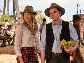 Charlize Theron, left, and Seth McFarlane star in "A Million Ways To Die In The West."