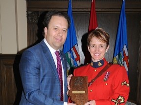 Spruce Grove/Stony Plain RCMP Cpl. Colette Zazulak (right) accepts the Community Justice Award from Minister of Justice Jonathan Denis. - Photo Supplied